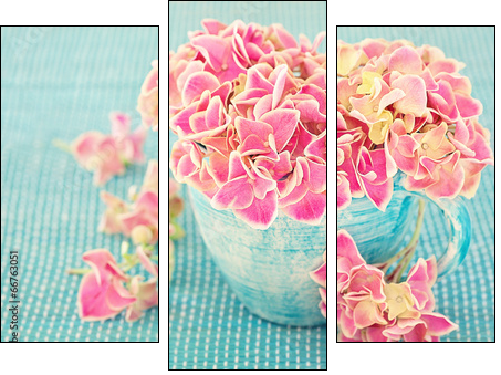 Pink hydrangea flowers in a cup on a blue background . - Three-piece canvas print, Triptych