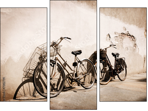 Italian old-style bicycles leaning against a wall  - Three-piece canvas print, Triptych