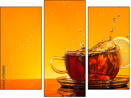 Tea splashing out of glass with orange background - Three-piece canvas print, Triptych
